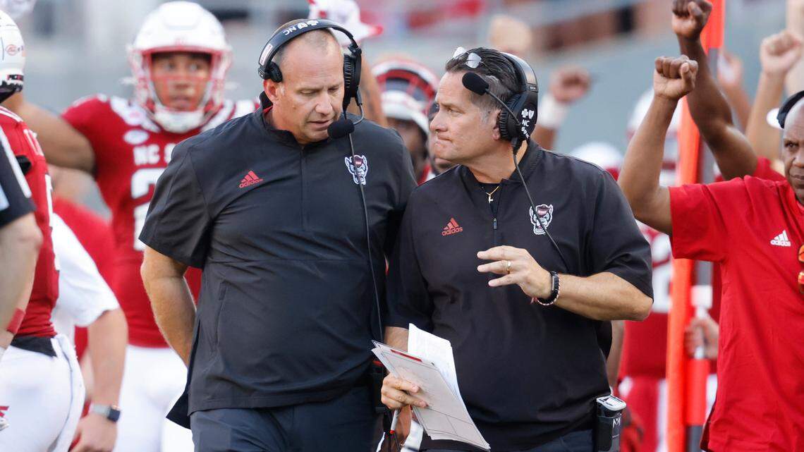 N.C. State head coach Dave Doeren, left, talks with offensive coordinator Tim Beck during the second half of N.C. State’s 27-21 overtime victory over Clemson at Carter-Finley Stadium in Raleigh, N.C., Saturday, Sept. 25, 2021.