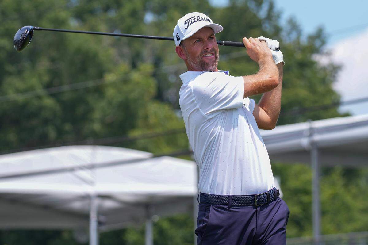 Webb Simpson plays from the 11th tee during the third round of the Wyndham Championship golf tournament.