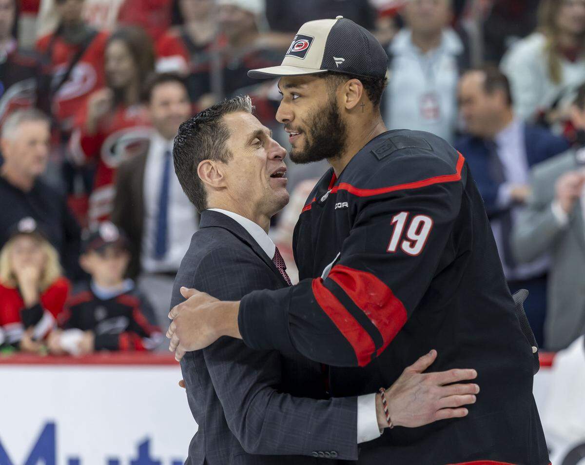 Carolina Hurricanes head coach Rod Brind’Amour embraces defenseman K’Andre Miller (19) following their 6-1 victory over Montreal, clinching the Eastern Conference, and advancing to the Stanley Cup Finals on Friday, May 29, 2026 at Lenovo Center in Raleigh, N.C.