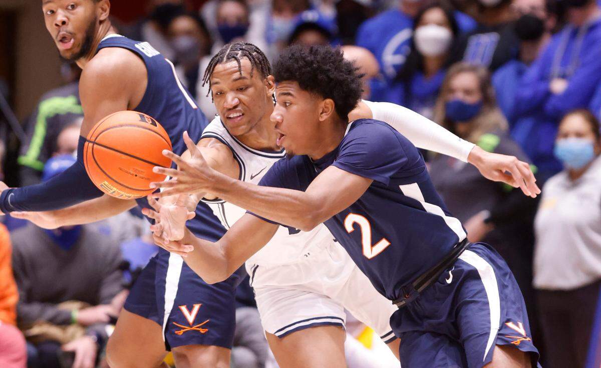 Virginia’s Reece Beekman (2) keeps the ball from Duke’s Wendell Moore Jr. (0) during the first half of Duke’s game against Virginia at Cameron Indoor Stadium in Durham, N.C., Monday, Feb. 7, 2022.