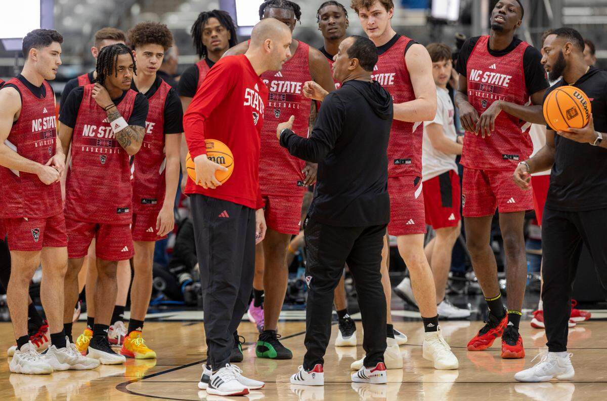 N.C. State’s Ben Middlebrooks (34) and his teammates listen to head coach Kevin Keatts and assistant coach Joel Justus during their open practice on Friday, April 5, 2024, as they prepare for their NCAA National Semi-Final game against Purdue at State Farm Stadium in Glendale, AZ.