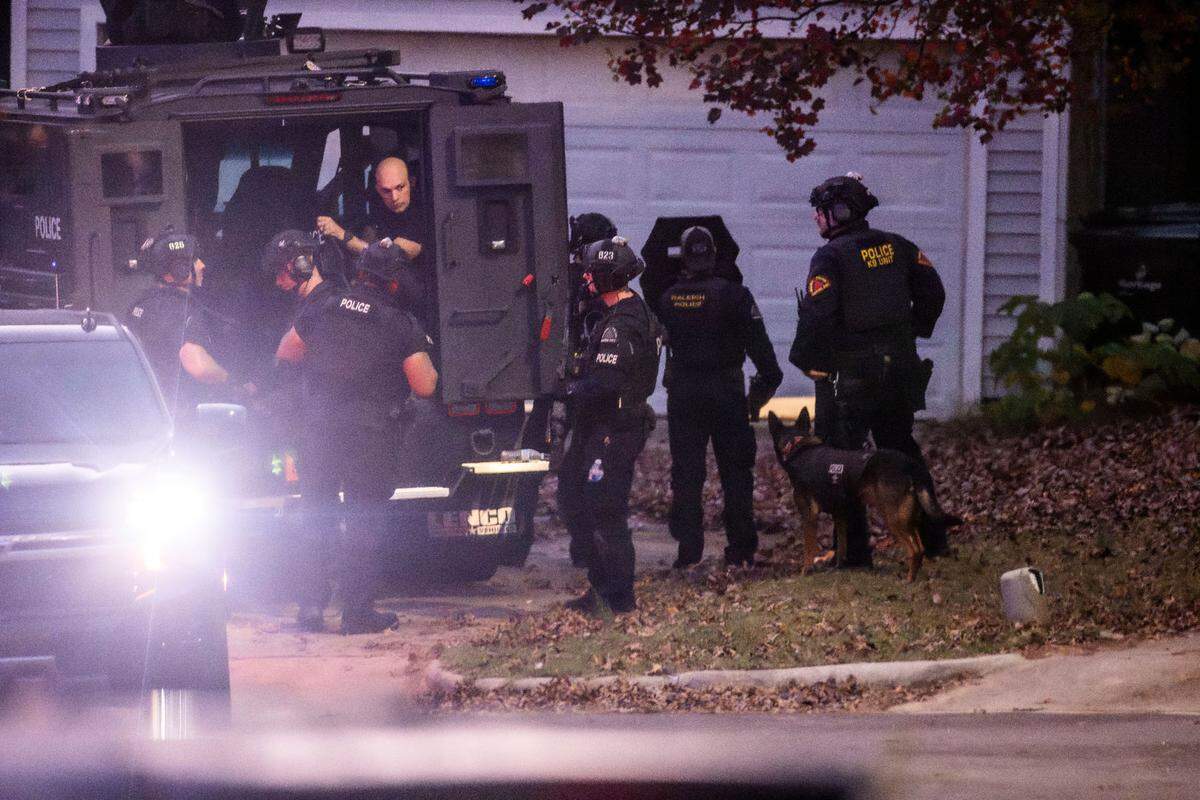 Raleigh Police, some in tactical gear, work the scene where two “persons of interest” were detained Thursday afternoon on Kentford Court in Raleigh Thursday, Nov. 7, 2024. Raleigh police are investigating shots fired into eight cars and four houses, a growing total in the recent series of rush-hour shootings along Interstate 40 and near I-440.