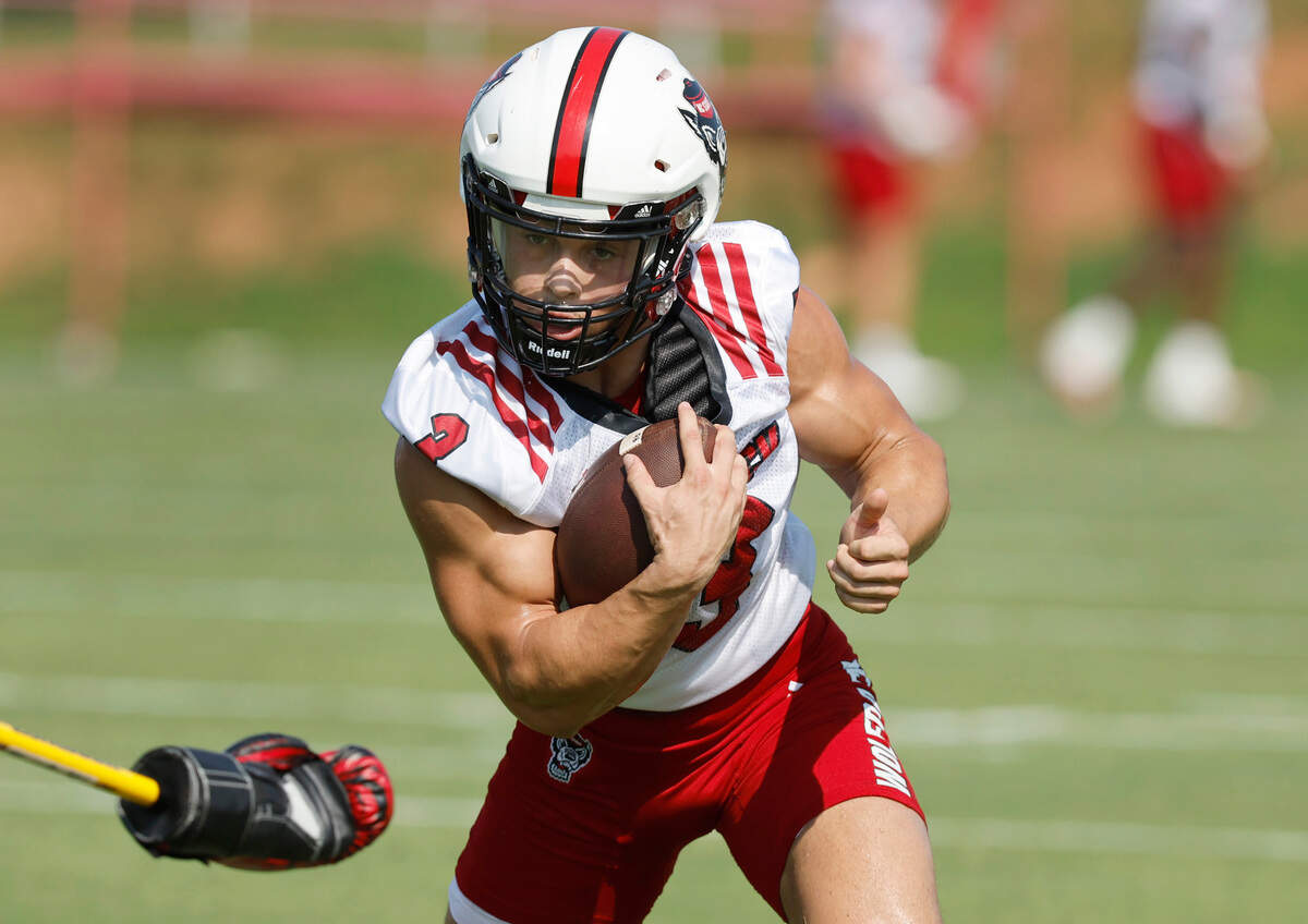 N.C. State running back Jordan Houston (3) runs upfield during a drill during the Wolfpack’s first practice of fall camp in Raleigh, N.C., Wednesday, August 3, 2022.