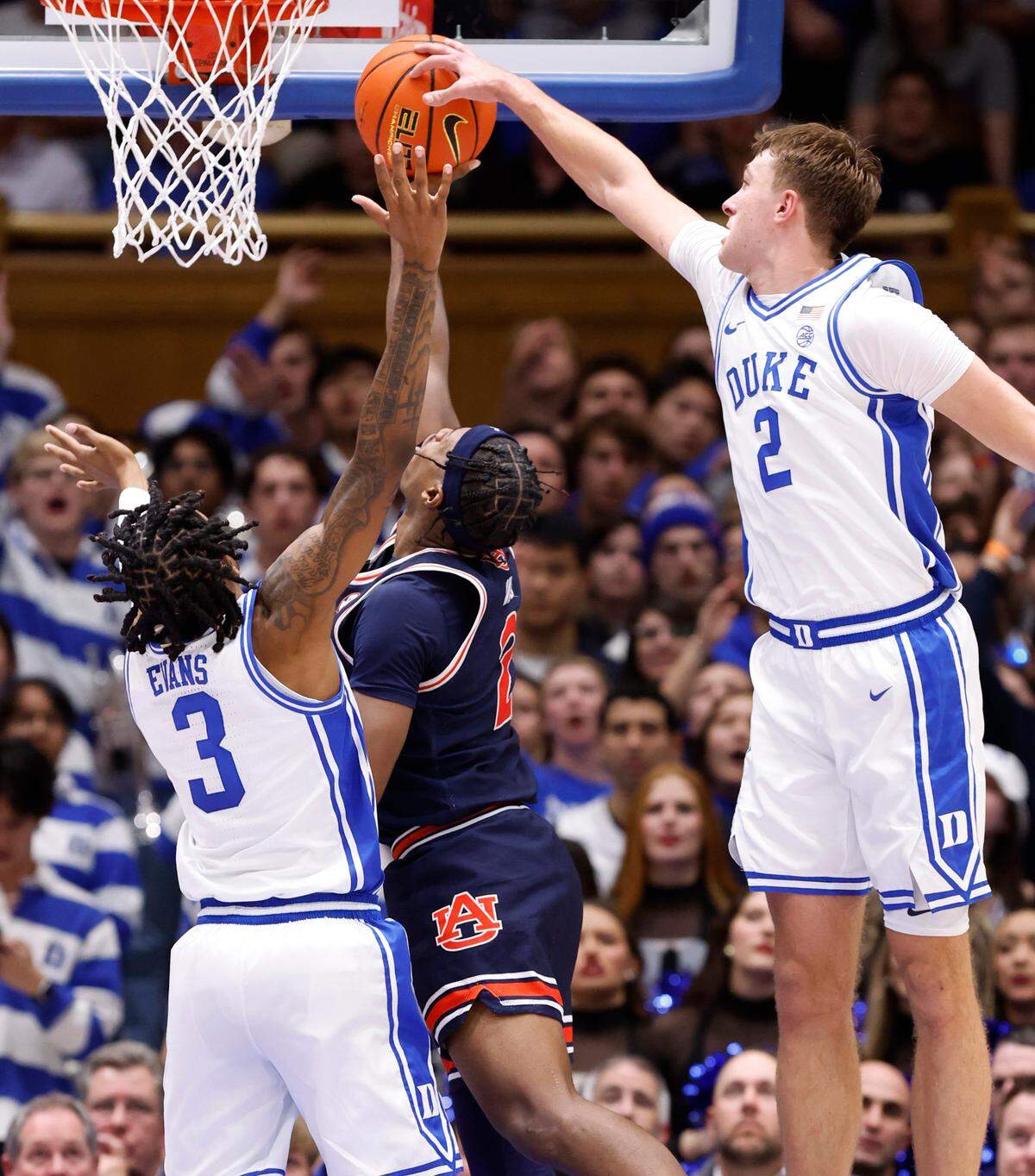 Duke’s Cooper Flagg (2) blocks the shot by Auburn’s Denver Jones (2) as Duke’s Isaiah Evans (3) also defends during the second half of Duke’s 84-78 victory over Auburn at Cameron Indoor Stadium in Durham, N.C., Wednesday, Dec. 4, 2024.