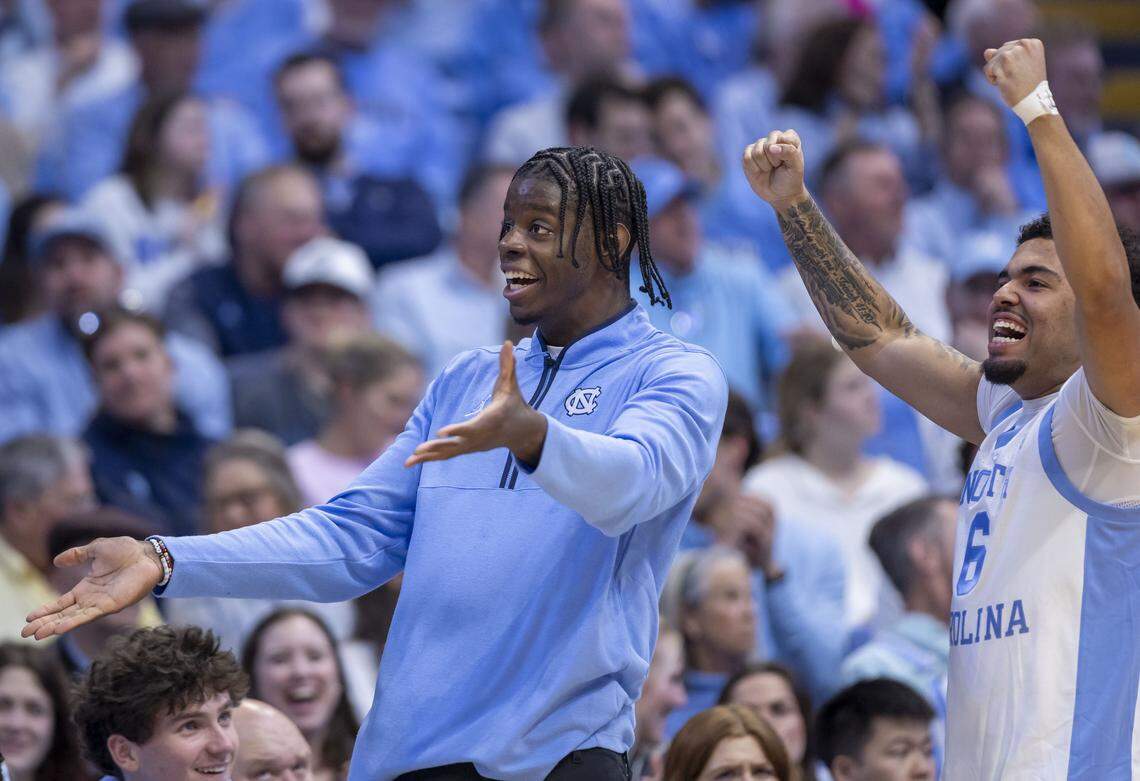 North Carolina forward Caleb Wilson, out recovering from an injured left hand, works with guard Elijah Davis (6) to motivate the fans in the student section during the second half against Clemson on Tuesday, March 3, 2026 at the Smith Center in Chapel Hill, N.C.