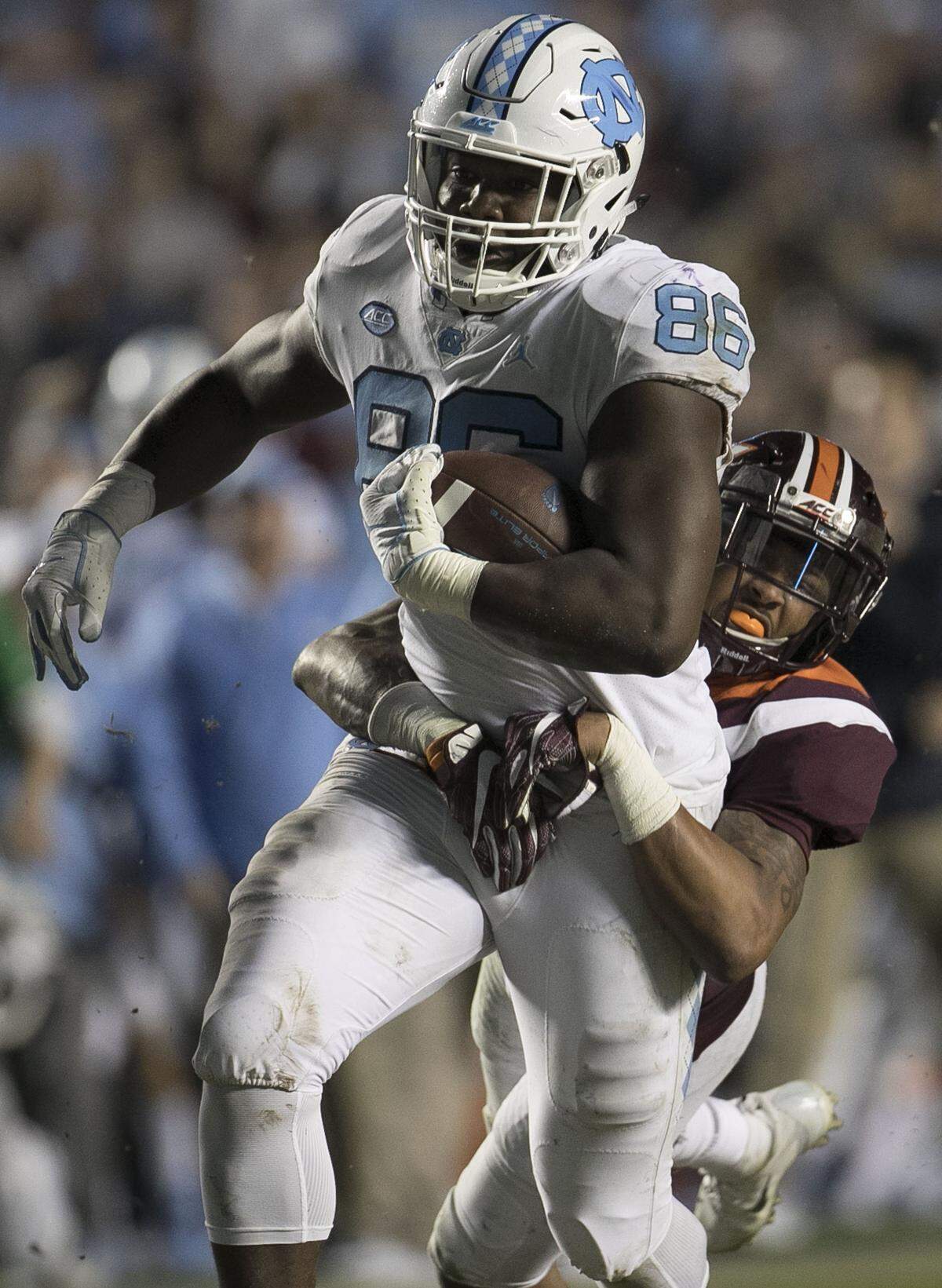 Virginia Tech’s Jovonn Quillen (26) tries to slow North Carolina’s Carl Tucker (86) as he romps for 80 yards on a pass completion from quarterback Nathan Elliott in the fourth quarter against Virginia Tech on Saturday, October 13, 2018 at Kenan Stadium in Chapel Hill, N.C.