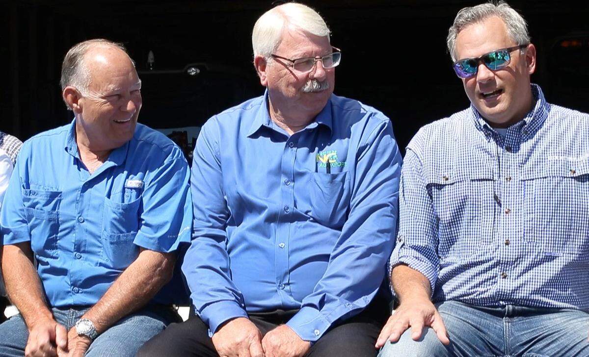 From left, Sen. Brent Jackson and Commissioner of Agriculture Steve Troxler chat with Lt. Gov. Dan Forest during a rally with farmers on Tuesday, July 10, 2018, at Joey Carter’s farm in Duplin County near Beulaville.