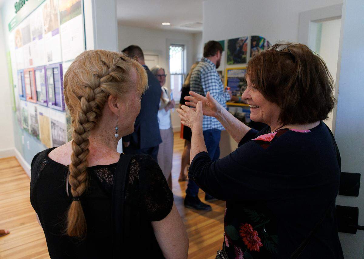 Diana Barefoot, right, smiles while reminiscing with Rebecca Withrow on Friday, May 31, 2024, inside a recently renovated historic house at Dorothea Dix Park in Raleigh, N.C. where her family once lived.