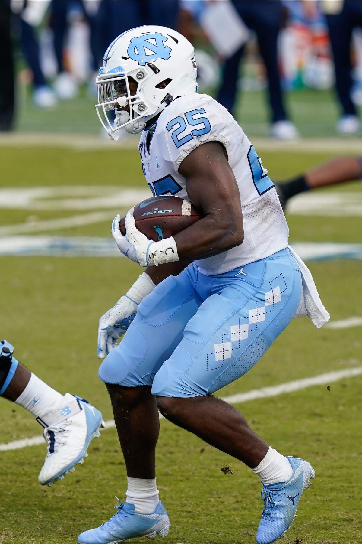 North Carolina Tar Heels running back Javonte Williams (25) runs through the line against the Duke Blue Devils during the second half at Wallace Wade Stadium. 