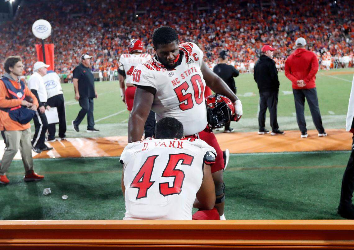 N.C. State center Grant Gibson (50) talks with defensive tackle Davin Vann (45) late in the second half of Clemson’s 30-20 victory over N.C. State at Memorial Stadium in Clemson, S.C., Saturday, Oct. 1, 2022.