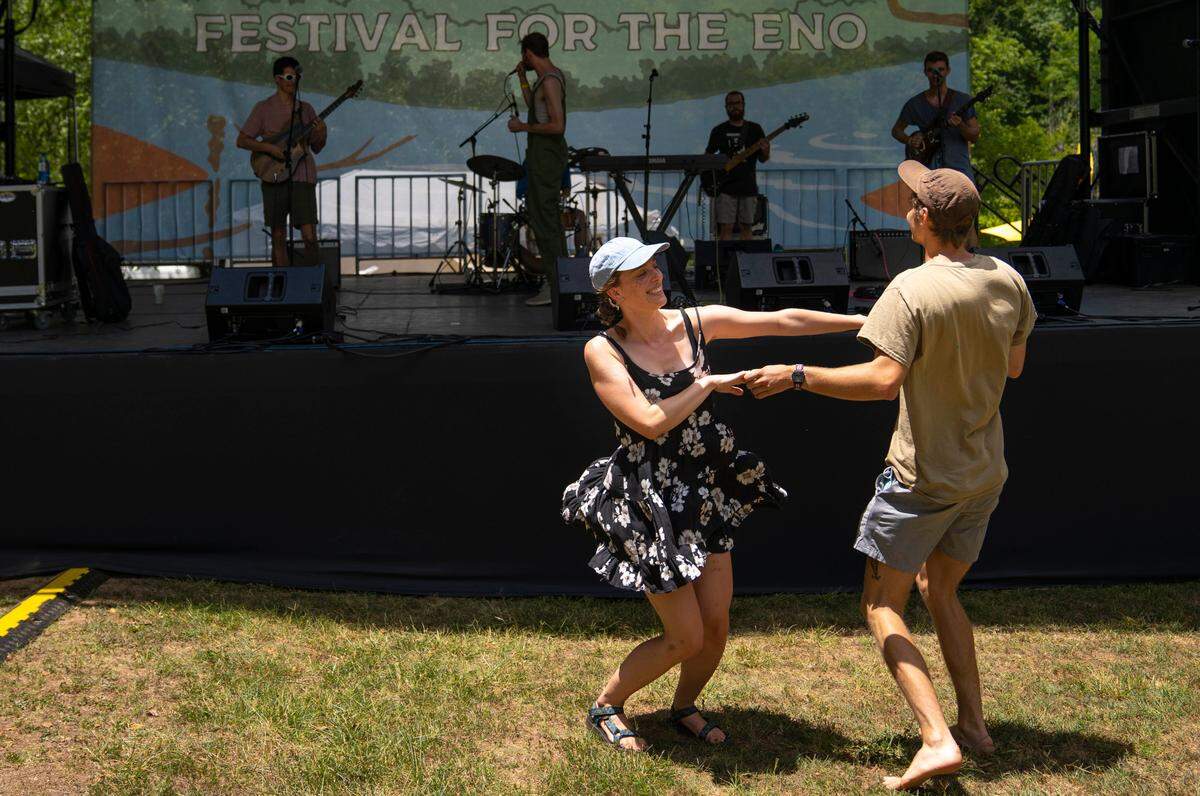 Sophie Lowry and Sam Finlay dance together during the Mellow Swellsí opening song at the Festival for the Eno on Saturday, July 2, 2022.