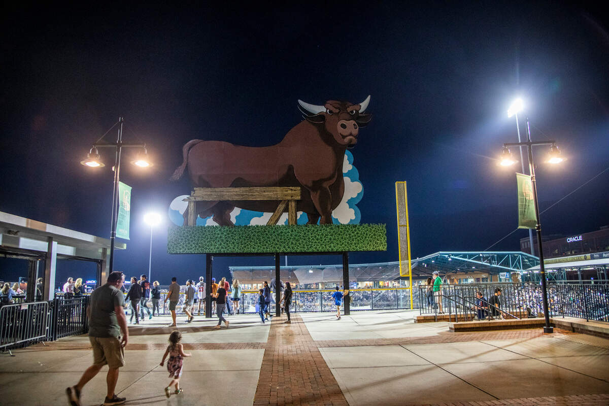 Fans walk behind the outfield during the Bulls’ season opener against the Jacksonville Jumbo Shrimp at the Durham Bulls Athletic Park, Tuesday, April 12, 2022.