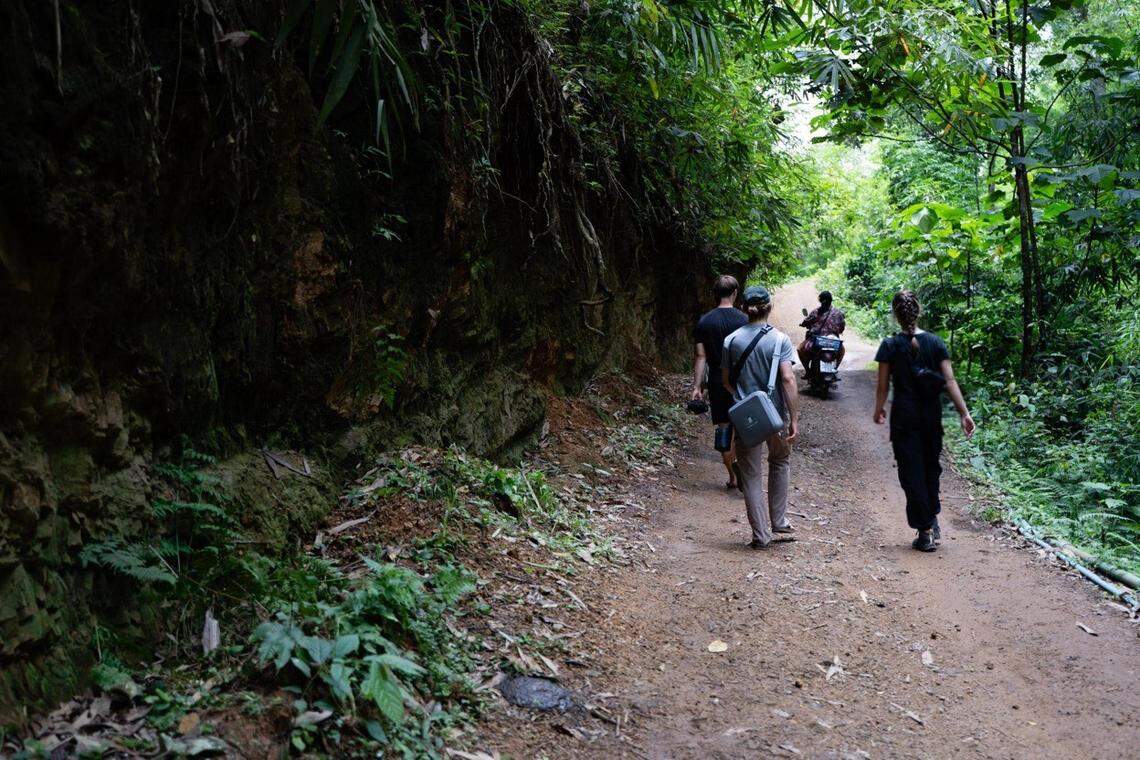 Hanna Yates walks with teammates on a dirt road inside Karenni State, Burma, where she was reporting on and meeting people.