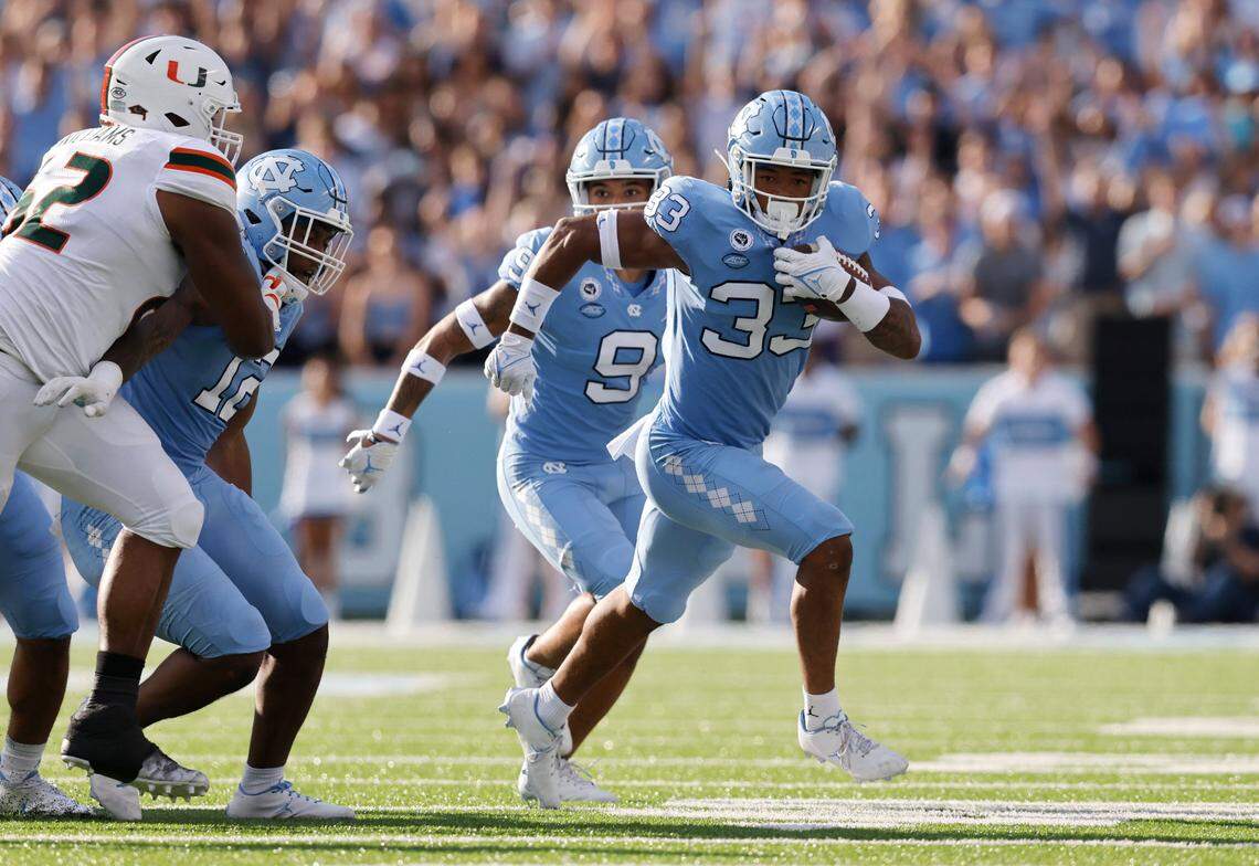UNC linebacker Cedric Gray (33) runs after intercepting the ball during the first half of North Carolinas game against Miami at Kenan Stadium in Chapel Hill, N.C., Saturday, October 16, 2021.
