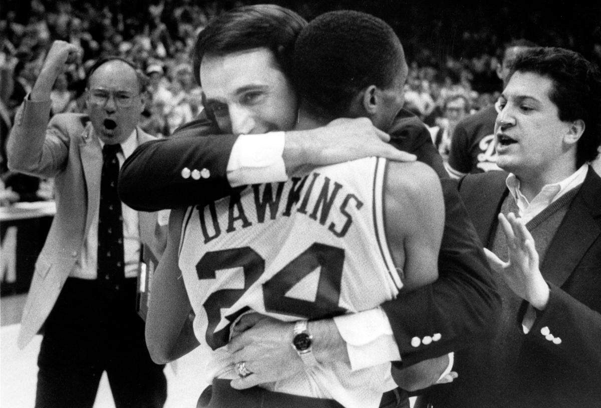Duke coach Mike Krzyzewski hugs point guard Johnny Dawkins after Duke defeated Georgia Tech to win the 1986 ACC Tournament, defeating Georgia Tech to win the title.