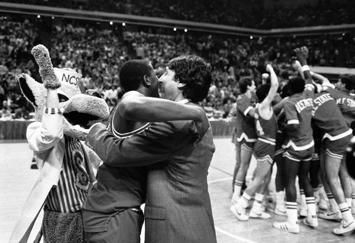 NC State head coach Jim Valvano embraces Dereck Wittenburg as the Wolfpack celebrates their 1983 ACC Tournament championship.