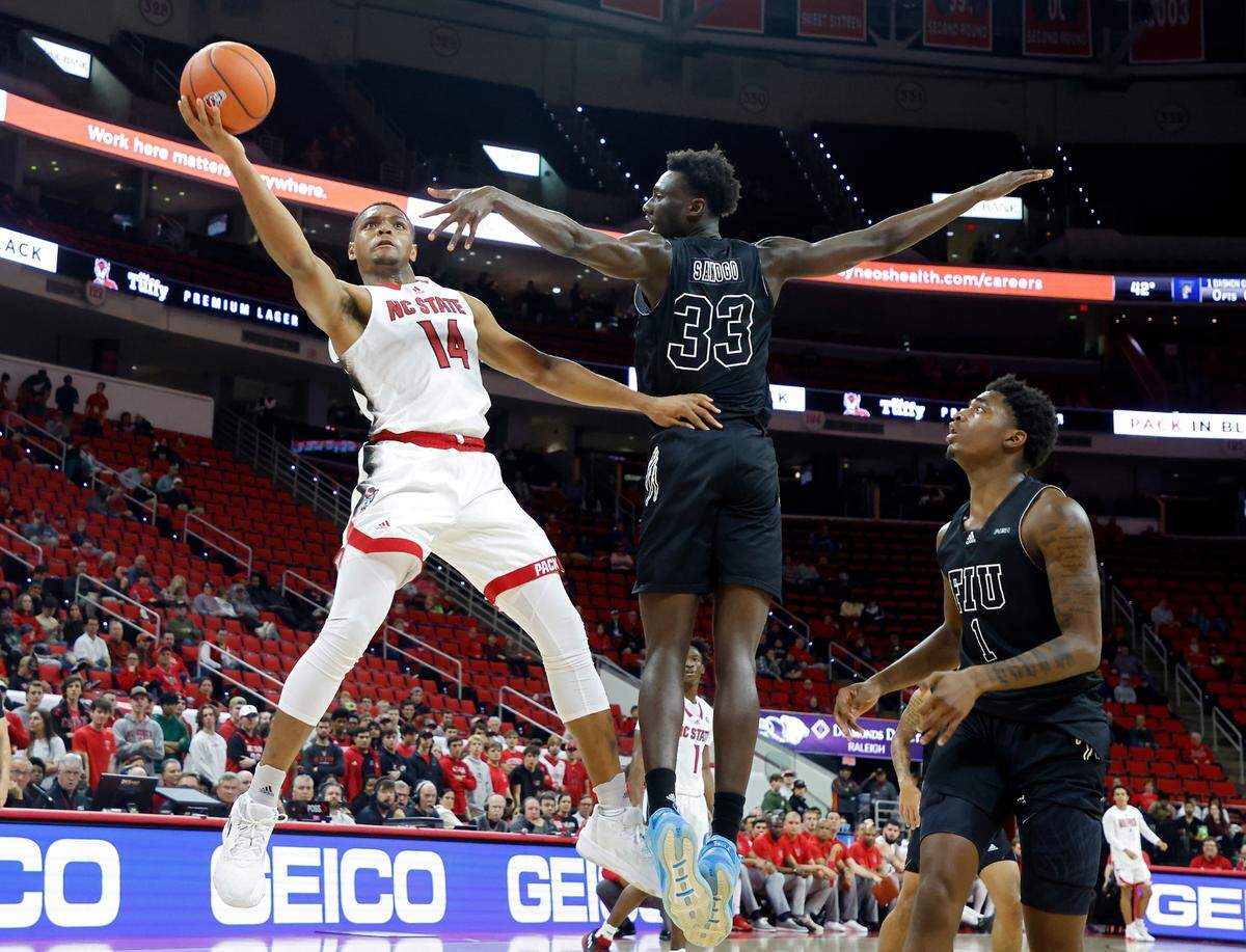 North Carolina State Wolfpack guard Casey Morsell shoots over Florida International Golden Panthers forward Mohamed Sanogo during the first half of a men’s basketball game at PNC Arena on Tuesday, Nov. 15, 2022, in Raleigh, N.C.