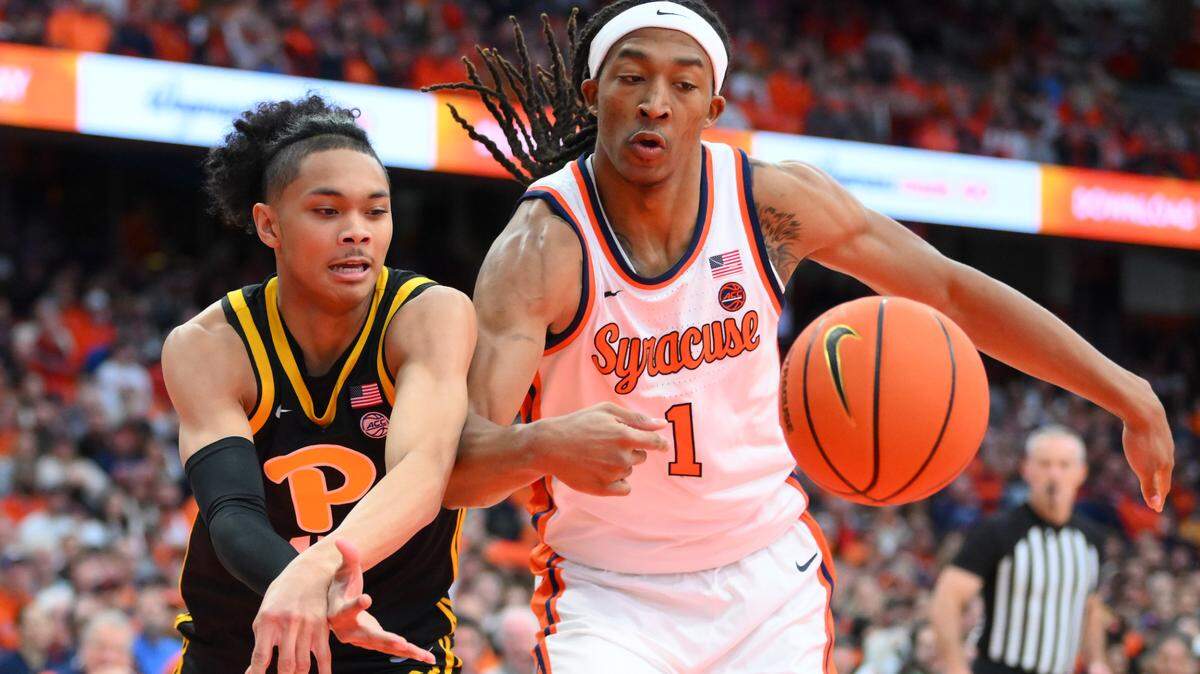 Pittsburgh Panthers’ Jaland Lowe (15) and Syracuse’ Maliq Brown (1) battle for a loose ball during their game in Pittsburgh in Dec. 2023.