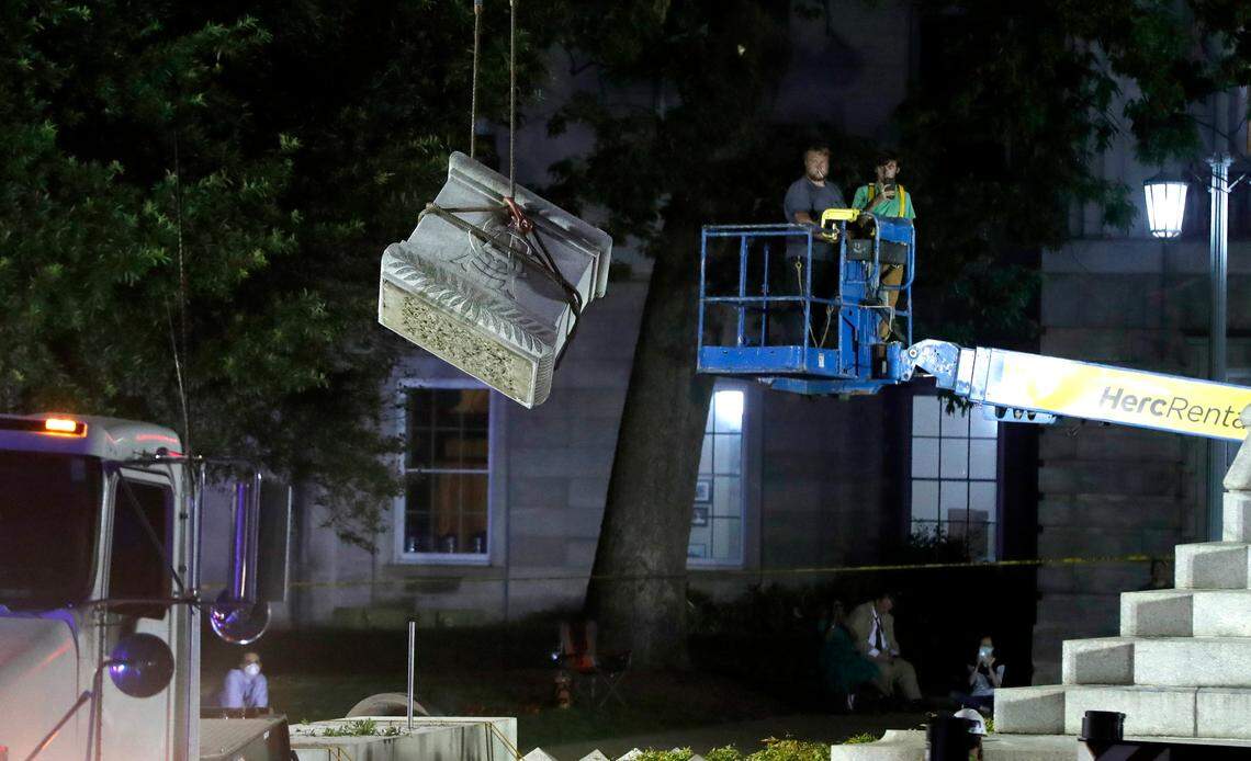 Crews remove a part of the Confederate monument on the grounds of the state Capitol in Raleigh, N.C., Tuesday evening, June 23, 2020. The 75-foot tall Confederate monument was removed after Gov. Roy Cooper cited public safety in ordering them to be taken down.