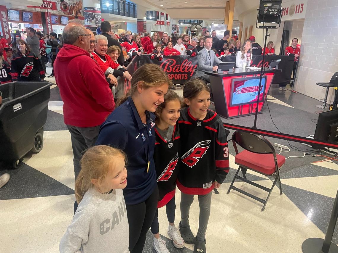 Mary Derrenbacher, second from left, poses with her World Women’s Under-18 gold medal and a few younger fans at the Carolina Hurricanes game on Sunday, March 10, 2024.