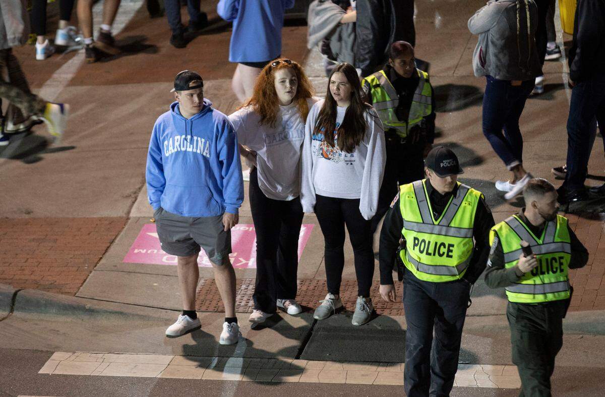Tar Heel fans grappling with UNC’s loss to Kansas in the NCAA Championship game start to leave downtown Chapel Hill, N.C. on Monday, April 4, 2022.