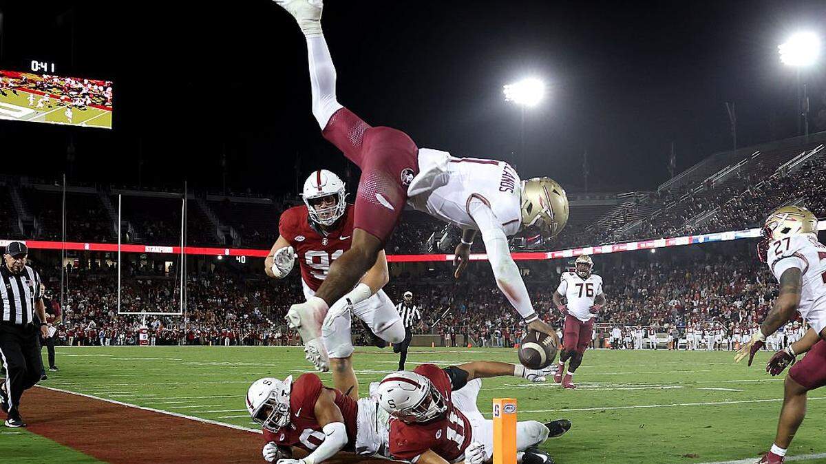 Tommy Castellanos of the Florida State Seminoles dives in for a touchdown over Tevarua Tafiti of Stanford in the first half at Stanford Stadium on Oct. 18, 2025 in Stanford, California. 