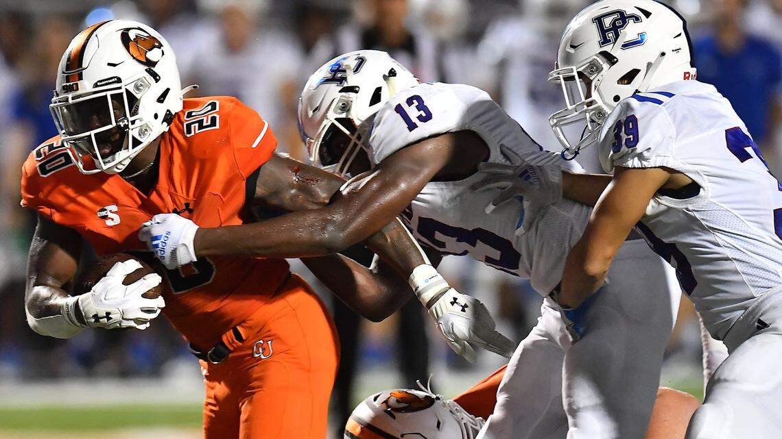 Presbyterian’s Brandon Dessi (13) grapples Campbell’s Michael Jamerson (20) during their game in Buies Creek, N.C. on September 18, 2021.