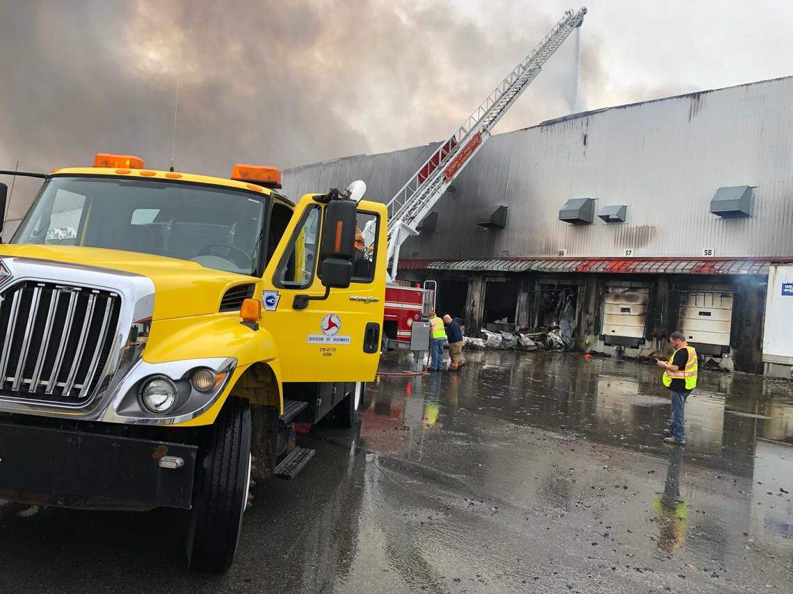 An engine from the Pinetops Fire Department spraying water into a section of the QVC distribution center near Rocky Mount, N.C. on the morning of Saturday, Dec. 18, 2021.