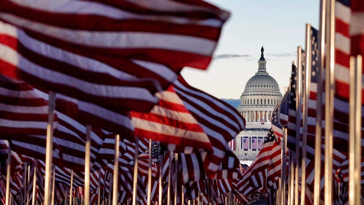 Flags line the National Mall towards the Capitol Building as events get underway for President-elect Joe Biden’s inauguration ceremony, Wednesday, Jan. 20, 2021, in Washington.
