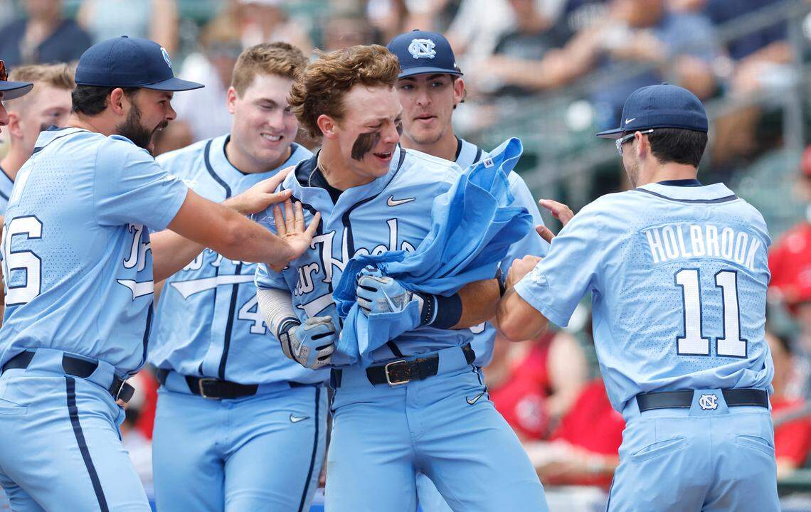 North Carolina’s Vance Honeycutt (7), holding the “Freakin Awesome” t-shirt, celebrates with teammates after hitting a two-run homerun in the first inning during N.C. State’s game against UNC in the ACC baseball championship at Truist Field in Charlotte, N.C., Sunday, May 29, 2022.