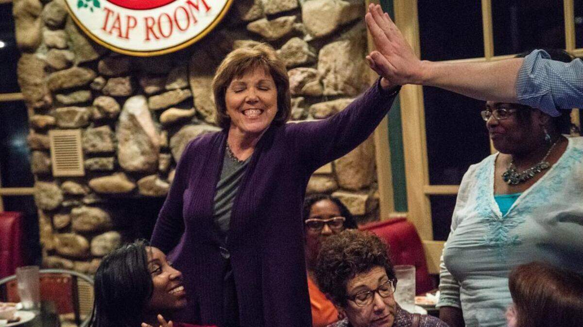 Wake commissioners District 4 seat challenger Susan Evans celebrates as she enters an election results watch party at Sawmill Tap Room in Raleigh Tuesday, May 8, 2018.