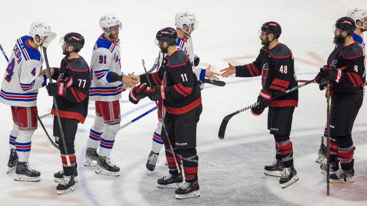The Carolina Hurricanes defenseman Tony DeAngelo (77) and teammates Jordan Staal (11), Jordan Martinook (48) and Brent Burns (8) congratulate the New York Rangers in the handshake line following their 5-3 loss and elimination from the Stanley Cup Playoffs on Thursday, May 16, 2024 at PNC Arena in Raleigh N.C.