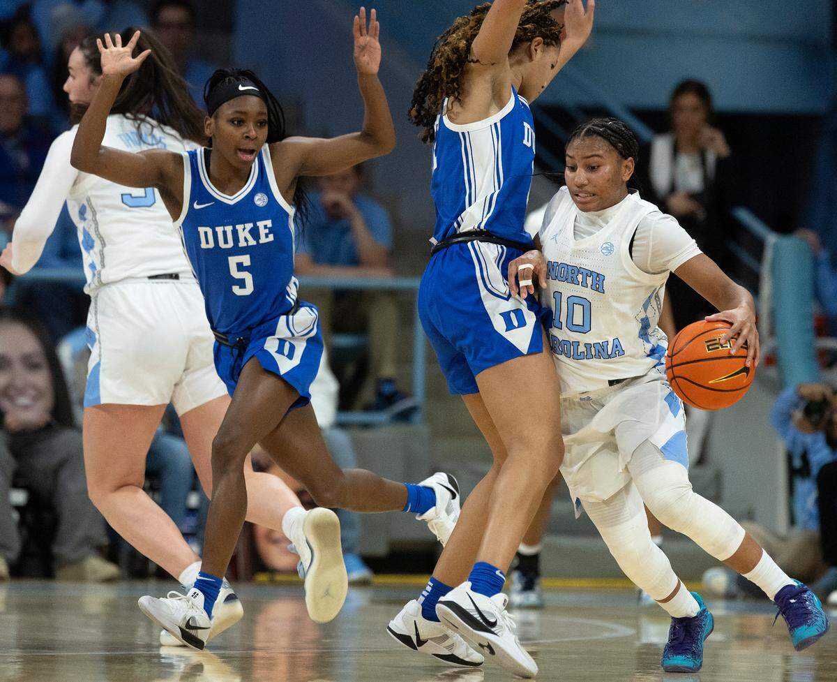 Duke’s Oluchi Okananwa and Delaney Thomas pressure North Carolina’s Reniya Kelly during overtime of the Blue Devils’ 53-46 loss on Thursday, Jan. 9, 2025, at Carmichael Arena in Chapel Hill, N.C.
