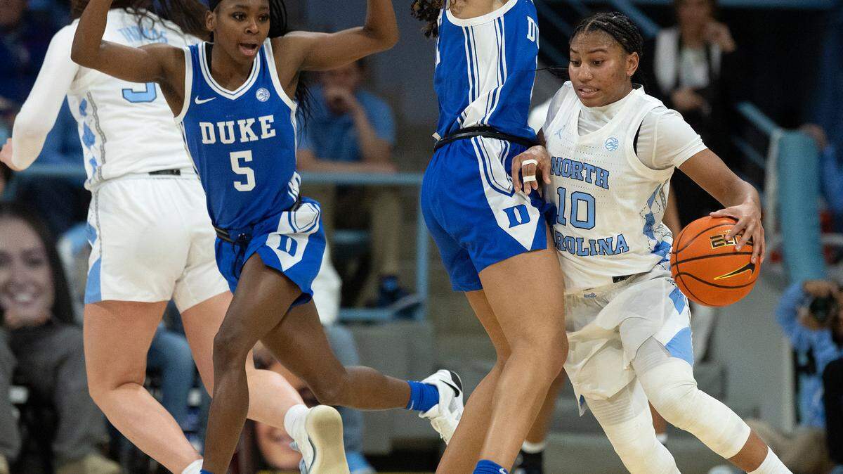 Duke’s Oluchi Okananwa and Delaney Thomas pressure North Carolina’s Reniya Kelly during overtime of the Blue Devils’ 53-46 loss on Thursday, Jan. 9, 2025, at Carmichael Arena in Chapel Hill, N.C.