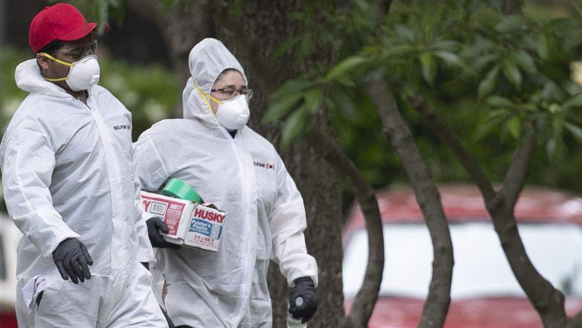 Construction workers dressed in personal protective equipment enter Brookdale Senior Living on Carlos Drive on Wednesday, May 13, 2020 in Raleigh, N.C. Brookdale is among two facilities in Wake County that have reported outbreaks of the coronavirus affecting residents and employees.