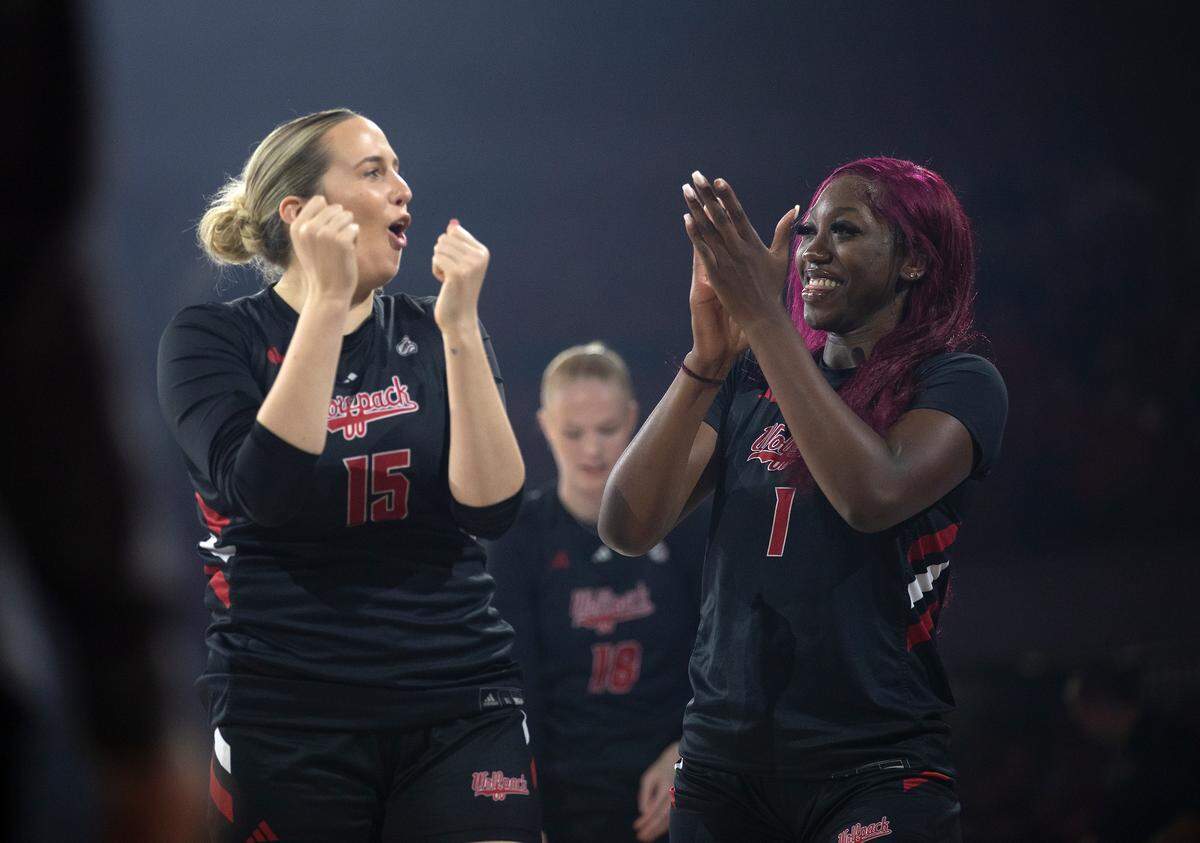 N.C. State’s Lizzy Williamson and Lorena Awou cheer prior to a three-point contest during the Primetime with the Pack preseason event on Friday, Oct. 25, 2024, at Reynolds Coliseum in Raleigh, N.C.