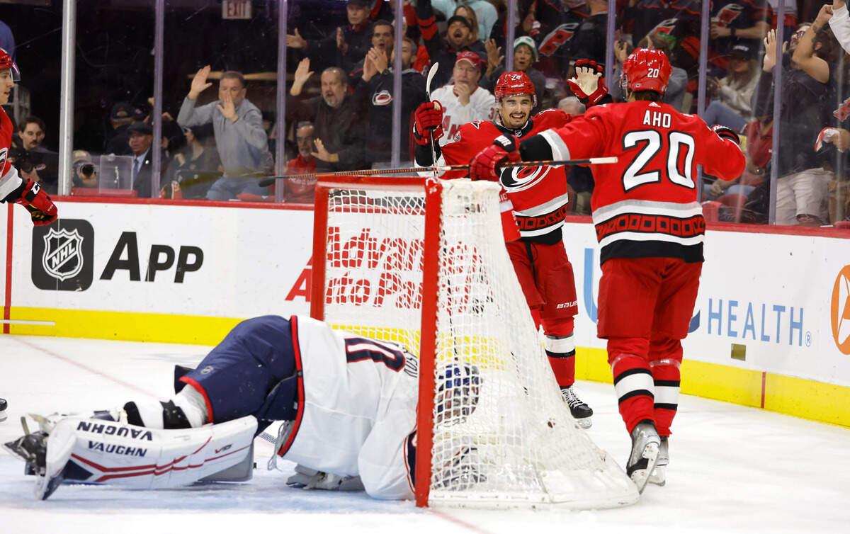 Carolina center Seth Jarvis (24) celebrates with Sebastian Aho (20) after Jarvis scored during the second period of the Carolina Hurricanes game against the Columbus Blue Jackets at PNC Arena in Raleigh, N.C., Wednesday, Oct. 12, 2022.