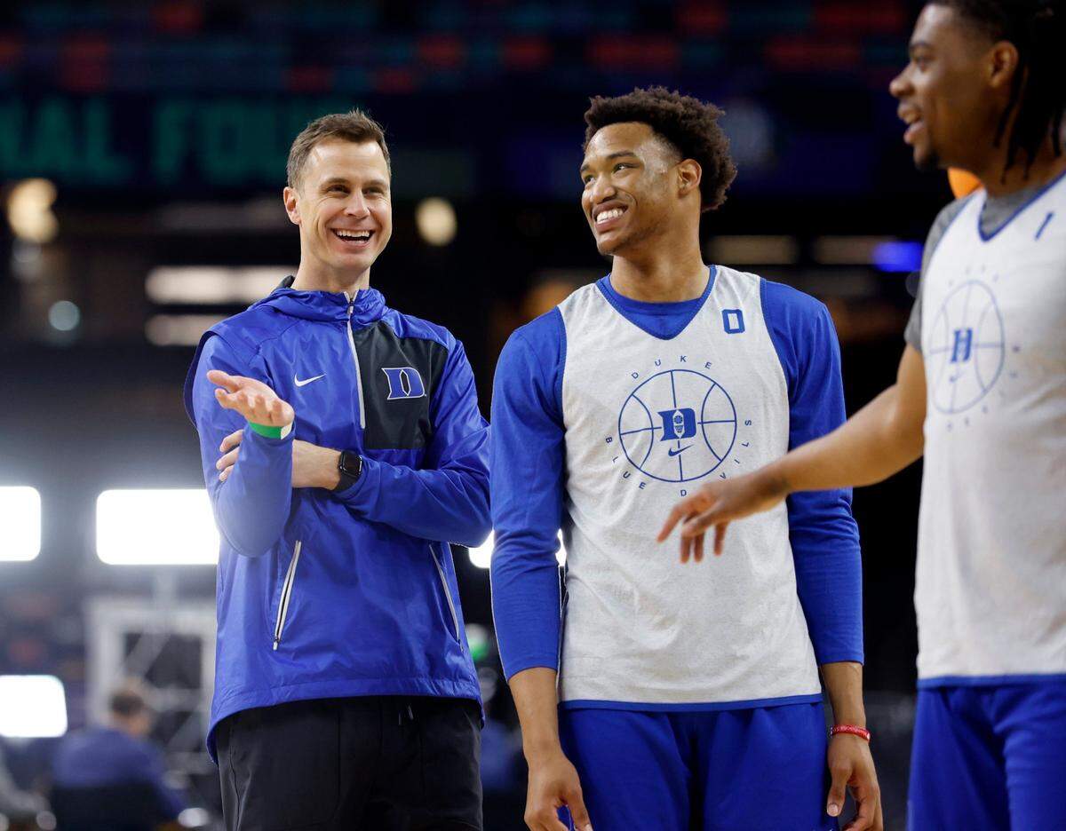Duke associate head coach Jon Scheyer laughs with Duke’s Wendell Moore Jr. (0) and Trevor Keels (1) during Dukes open practice at the Caesars Superdome in New Orleans, La., Friday, April 1, 2022. North Carolina will face Duke in the Final Four Saturday.