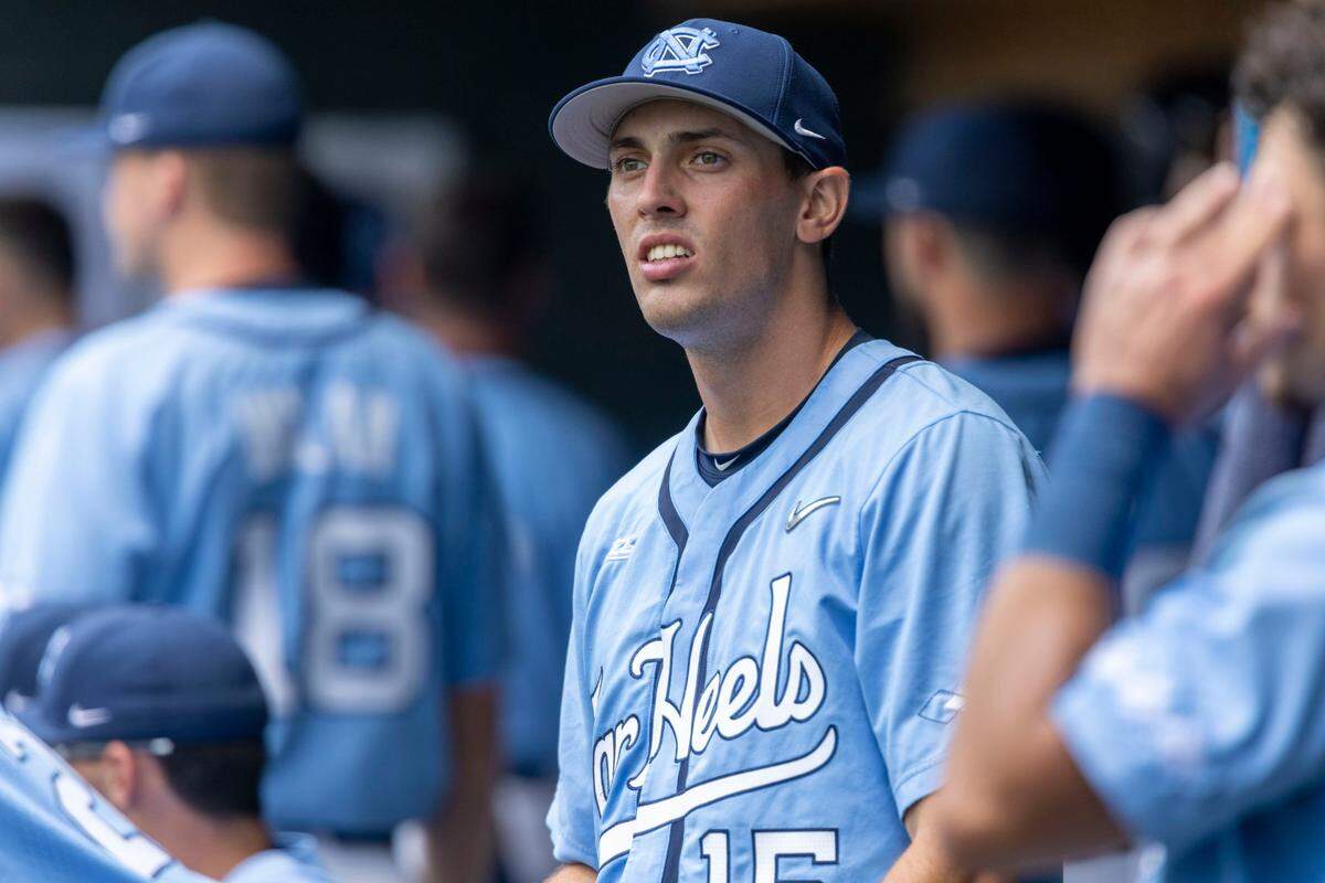 North Carolina pitcher Eric Grintz (5) watches as fans leave Boshamer Stadium and storm clouds roll in, causing a weather delay in the second inning during the Tar Heels game against Arkansas on Sunday, June 12, 2022 at Boshamer Stadium in Chapel Hill, N.C