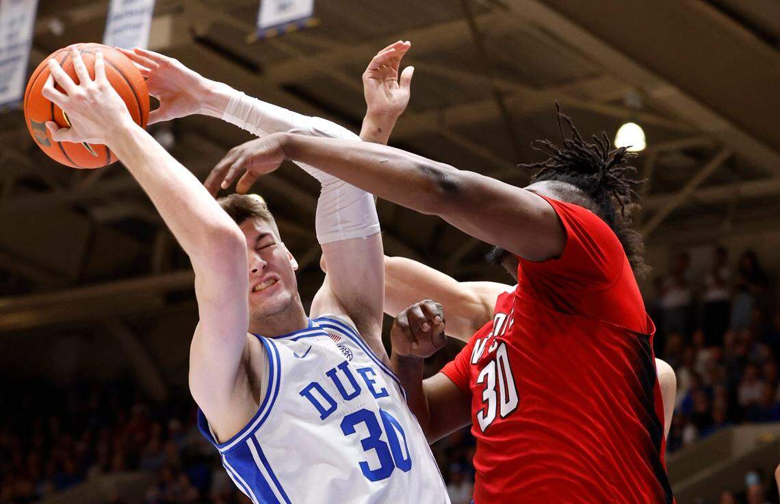 Duke’s Kyle Filipowski (30) pulls in the rebound from N.C. State’s D.J. Burns Jr. (30) during the first half of N.C. State’s game against Duke at Cameron Indoor Stadium in Durham, N.C., Tuesday, Feb. 28, 2023.