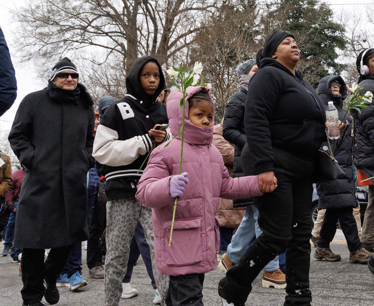 Lamiyah Cannon, 6, center, walks with her mother, Britney Cannon, along Boylan Avenue during the Walk for Peace on Saturday, Jan. 24, 2026, in Raleigh, N.C.