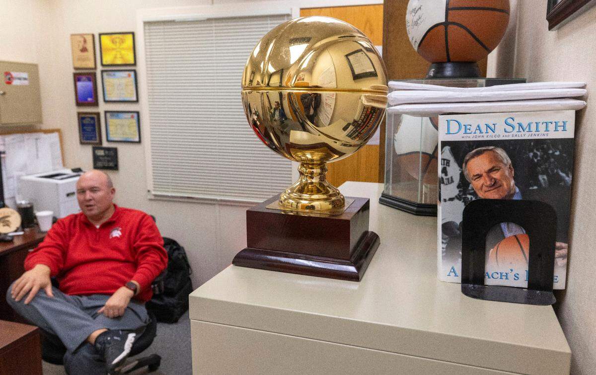 Emporia High School athletic director Beau Welch in his office with the ‘Dean Smith Traveling Trophy’ on Wednesday, November 6, 2024 in Emporia, Kansas.  The trophy to goes to the winner of the annual Emporia vs. Topeka basketball game in honor of legendary North Carolina basketball coach, an Emporia native.  