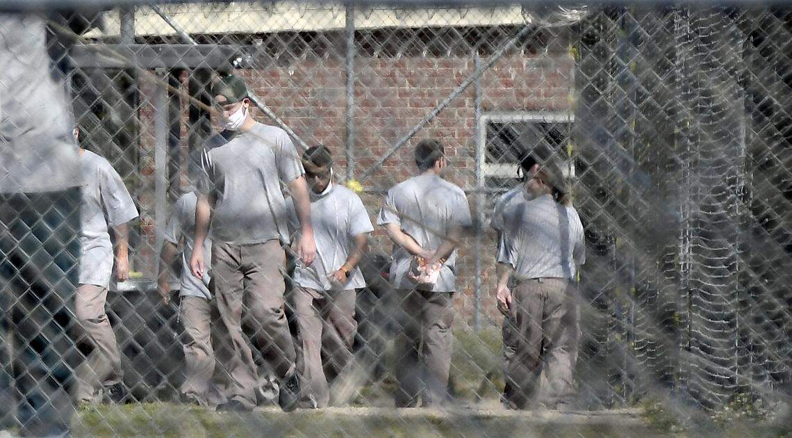 Inmates at the Neuse Correctional Institution in Goldsboro, N.C. move between buildings Sunday morning, April 19, 2020.