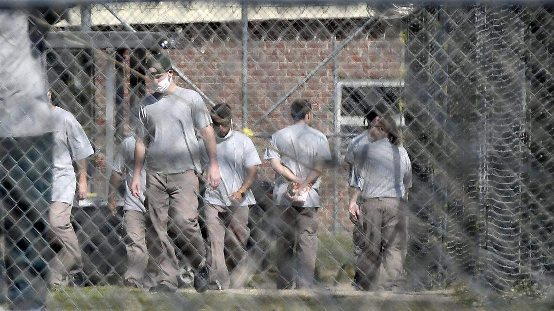 Inmates at Neuse Correctional Institution in Goldsboro, N.C. - the site of the first COVID-19 outbreak in the state’s prisons - move between buildings on April 19, 2020.