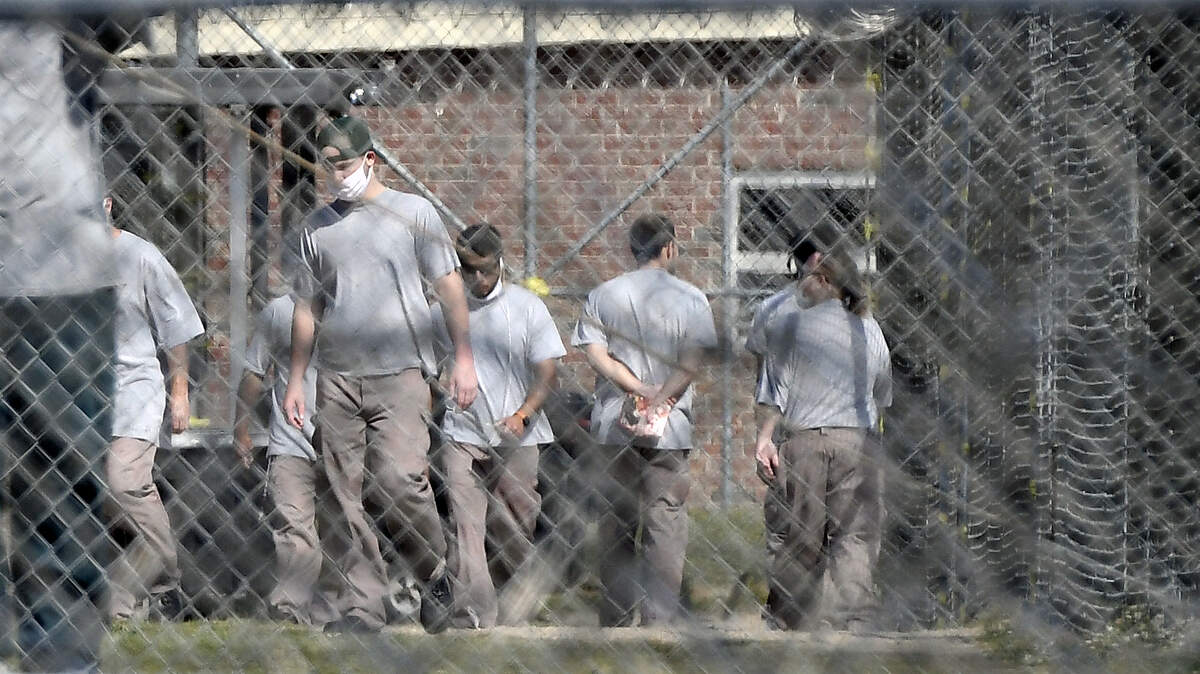 Inmates at Neuse Correctional Institution in Goldsboro, N.C. - the site of the first COVID-19 outbreak in the state’s prisons - move between buildings on April 19, 2020.