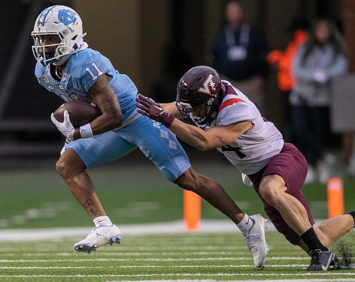 North Carolina wide receiver Josh Downs (11) looks for running room after a 33-yard pass completion from quarterback Drake Maye in the third quarter on Saturday, October 1, 2022 at Kenan Stadium in Chapel Hill, N.C.