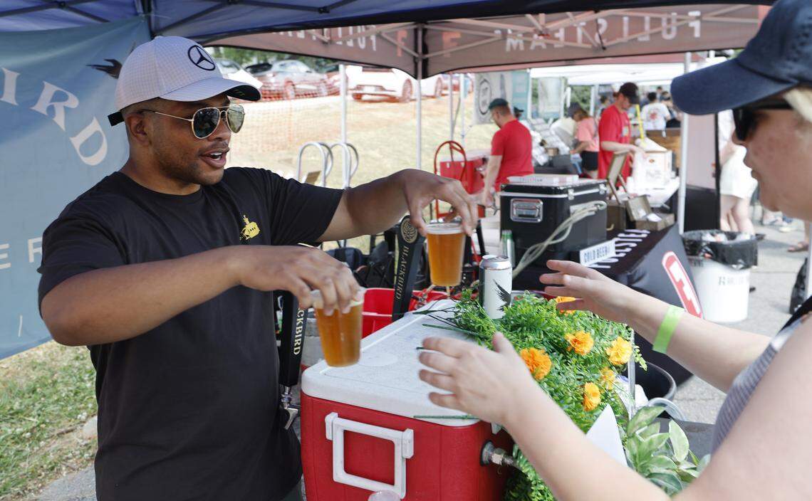 Chris Joseph with Blackbird Brewery in Wake Forest serves Roofless Ride, a Rye IPA, at the Y’all Means All NC Beer Festival at Raleigh Brewing in Raleigh, N.C., Saturday, April 25, 2026.