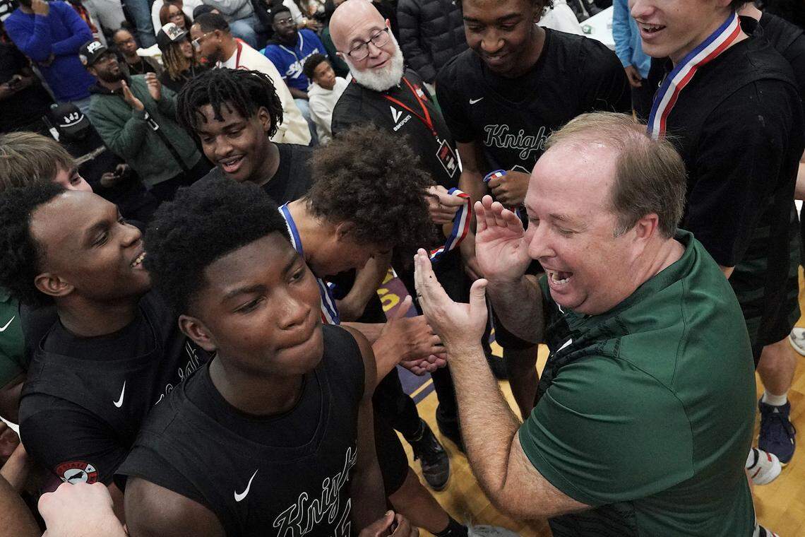 Greenfield head coach Rob Salter celebrates with his team after their victory over Coronado for the Day'Ron Sharpe bracket championship title. The Greenfield Knights and the Coronado Cougars (Nevada) met in the finals of the Day'Ron Sharpe bracket of the  John Wall Holiday Tournament in Raleigh, N.C. on December 30, 2025.