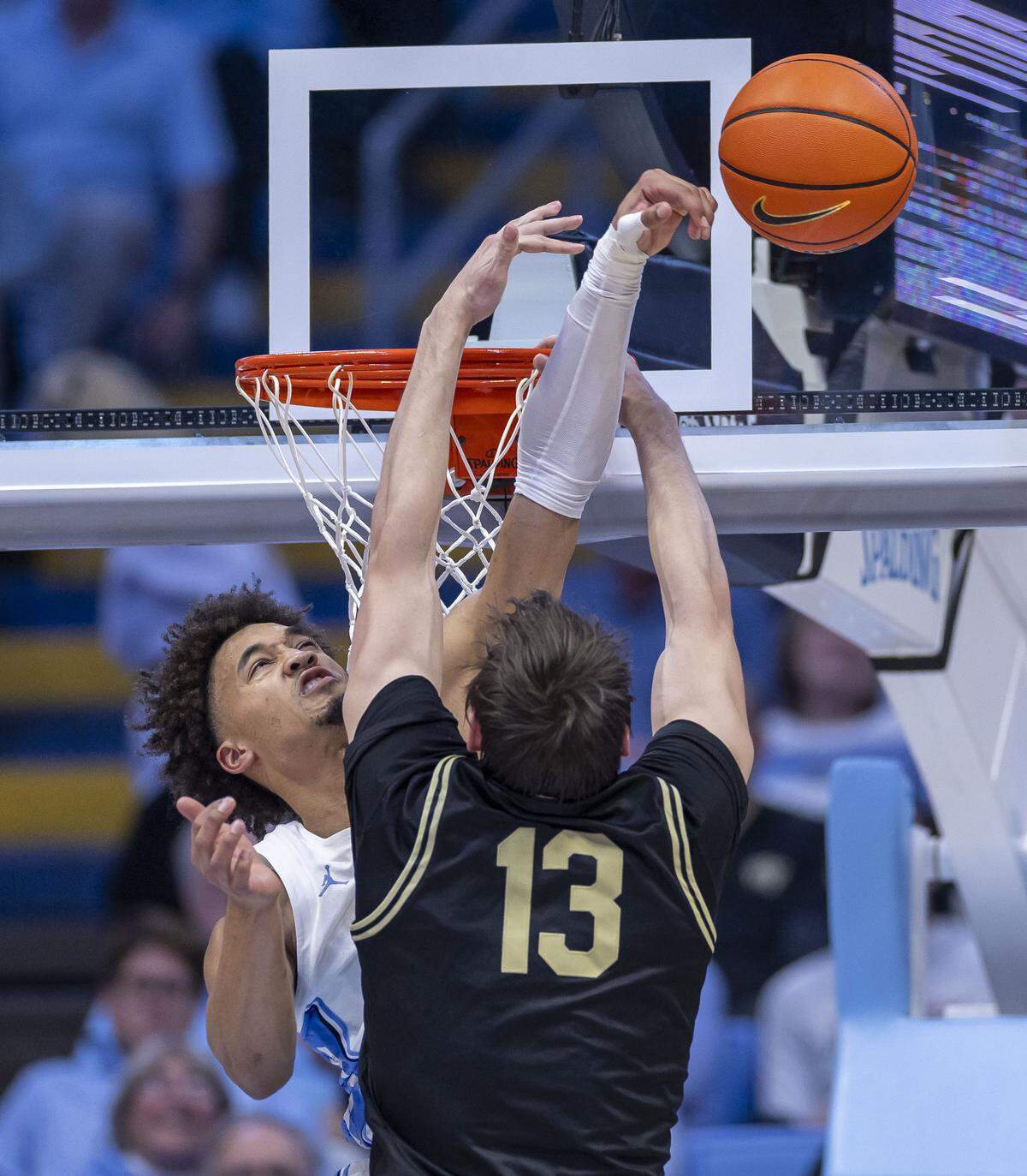 North Carolina guard Seth Trimble (7)  blocks a shot by Wake Forest Guard Cooper Schwieger (13) late in the second half on Saturday, January 10, 2026 at the Smith Center in Chapel Hill, N.C.