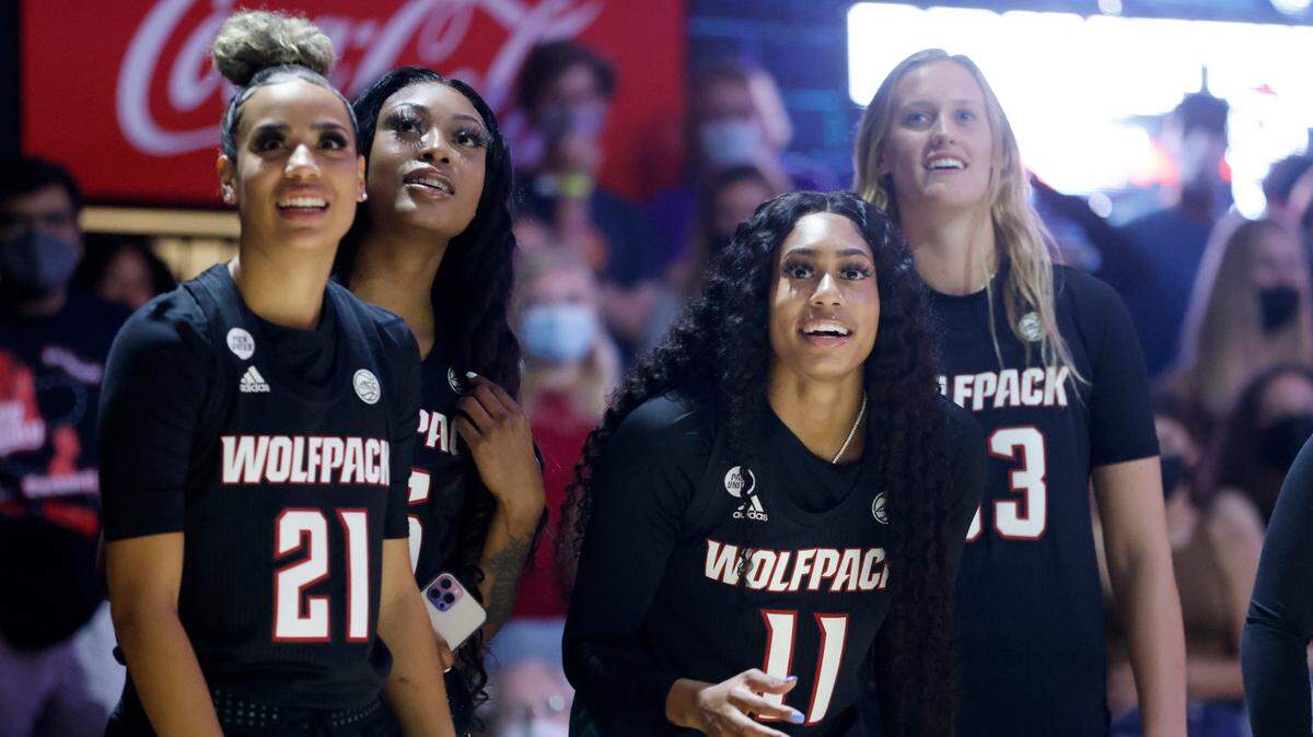 From left, N.C. State’s Madison Hayes (21), Jada Boyd (5), Jakia Brown-Turner (11) and Elissa Cunane (33) watch to see if a half court shot fall during Primetime with the Pack at Reynolds Coliseum in Raleigh, N.C., Thursday, October 14, 2021.